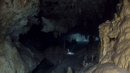 A dramatic view inside a vast, dark cave with stunning rock formations.