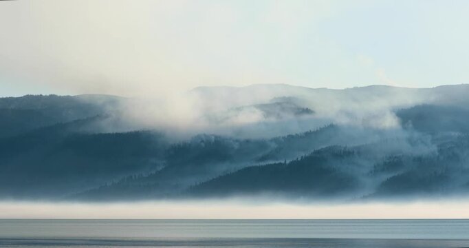A foggy mountain range is visible in the distance