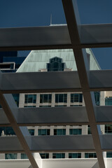 A close-up shot of older architectural styles reflecting in modern glass skyscrapers, showcasing...