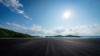 Naklejka premium Vast sandy beach under a bright blue sky with distant islands and lush green hills