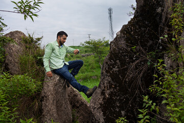 Man exploring rocky landscape in scenic himachal nature