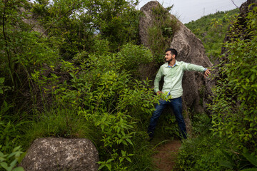 Man posing in green landscape himachal pradesh