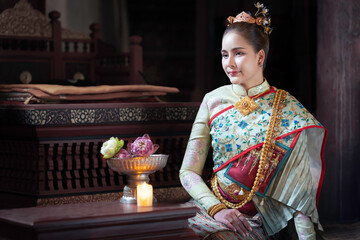 Pretty Asian Thai woman wearing traditional Thai dress costumes according to Thai culture at the...
