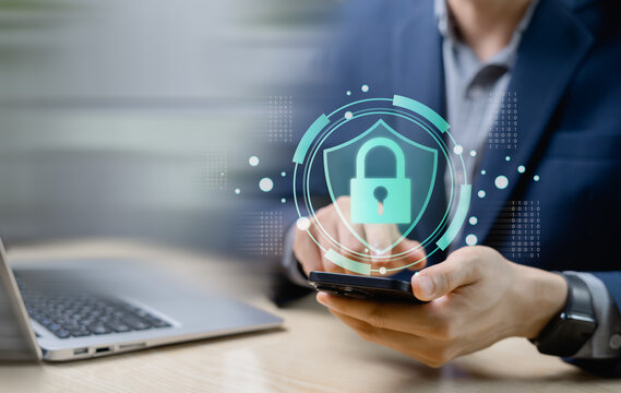 Close-up of person using smartphone with digital shield and lock icon. Concept of cybersecurity, mobile data protection, secure authentication, and digital identity safety.