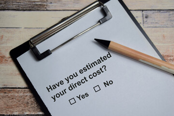 Have you estimated your direct cost write on clipboard isolated on Wooden Table. A person is...