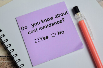 Do you know about cost avoidance write on sticky notes isolated on Wooden Table. A person is...