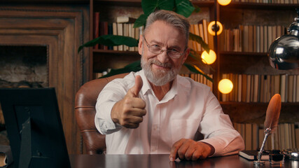 Confident successful old Caucasian man male mature takes off glasses looking at camera folded hands...