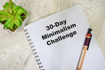 Concept of 30 day minimalism challenge write on book isolated on Wooden Table.