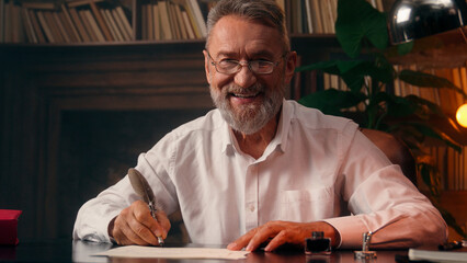 Confident successful old Caucasian man male mature takes off glasses looking at camera folded hands...