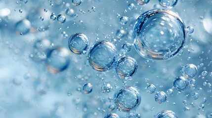 Scattered clear bubbles inside light blue liquid, abstract cleanliness