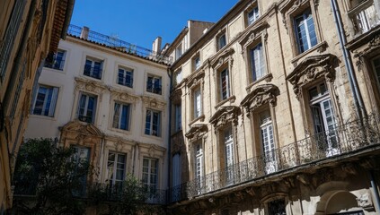 Fototapeta premium Buildings in French city courtyard, sunny day, blue sky background, use for architecture