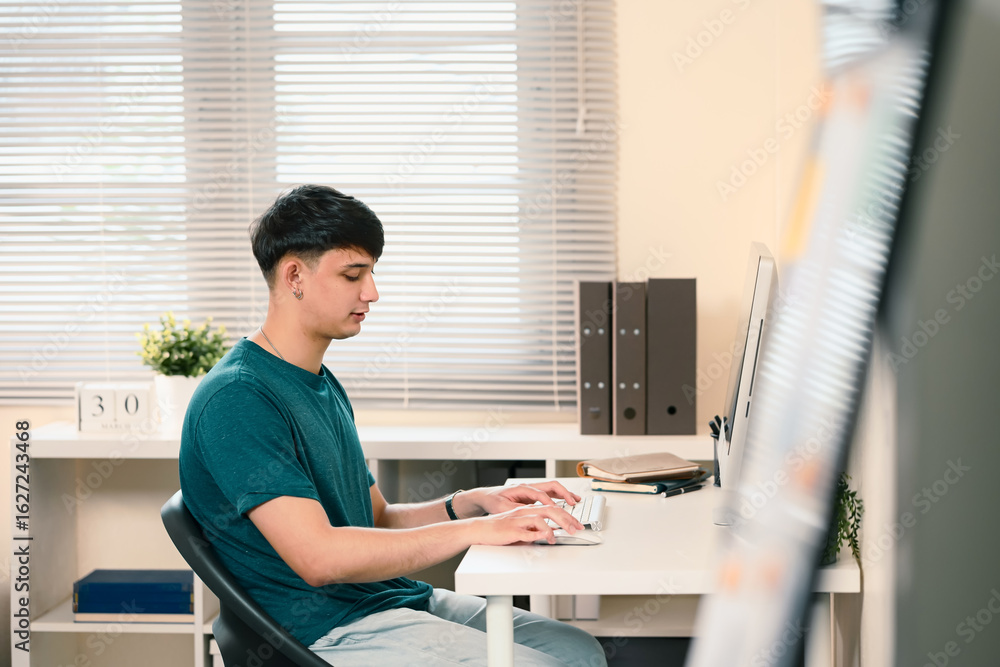 Poster side view of freelancer focused on work from home sitting at desk with computer