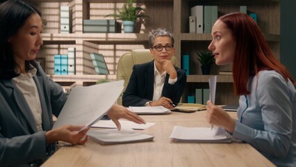 Business team talking discuss group paperwork collaboration businesswomen coworkers Caucasian Asian...