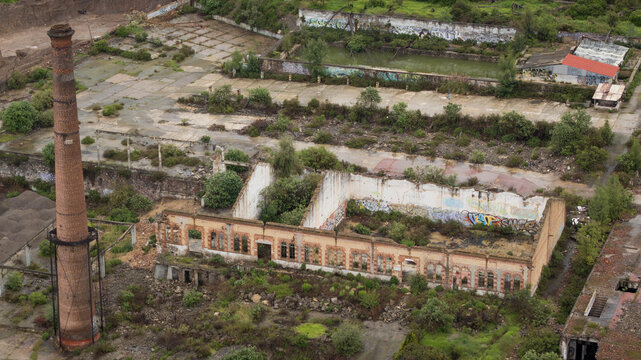 Drone view of old factory chimney on demolition site