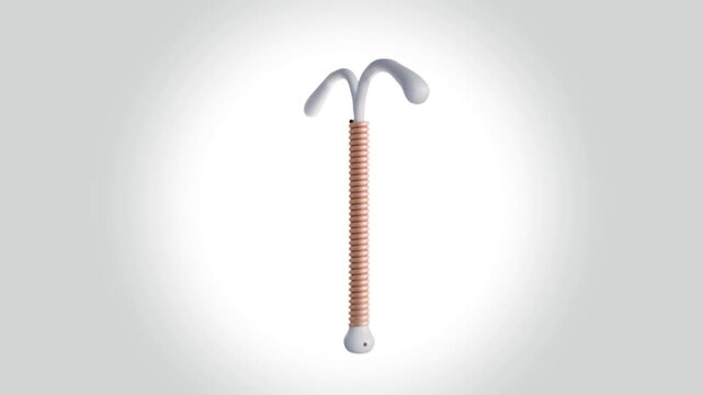 A 3D animation of a copper IUD or Intrauterine Device. The vertical stem of the 'T' is wrapped tightly with a coiled, copper-colored wire. The type of contraceptive.