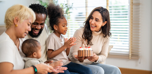 African love big family celebrating birthday party, mother holding cake for daughter, father, aunt and baby singing happy birthday, joyful moment, candles, surprise, special day and happiness at home