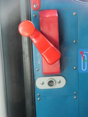 Red and white knob on a blue door