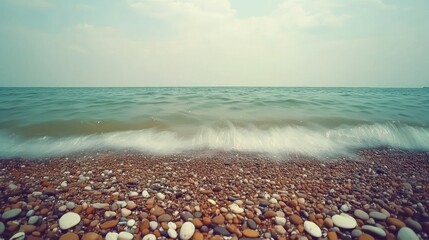 Serene Coastal Pebbles: Gentle Wave Wash on a Tranquil Beach