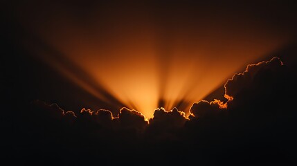 Dramatic sunset rays piercing dark cloudscape.