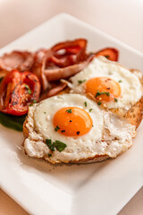 Fried Eggs & Bacon On Toast With Tomato