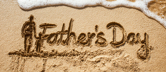 Father's Day Written in Wet Golden Sand with Minimalist One-Line Father and Child Drawing Beside Text and Gentle Ocean Wave