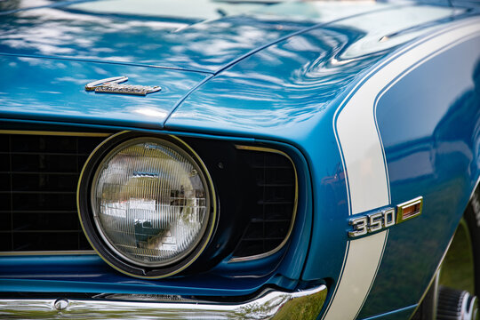 Front Detail of Classic Blue Chevrolet Camaro 350 Headlight and Emblem