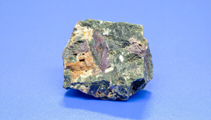 Stone Specimen on a blue surface: A detailed shot reveals a fascinating rock formation. This image offers a clear view of geological intricacies. 