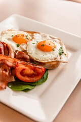 Fried Eggs & Bacon On Toast With Tomato