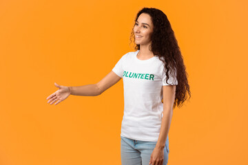 Side View Of Volunteer Lady Stretching Hand For Handshake Greeting Aside Posing Standing Over...