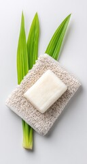 Natural bar soap on a beige towel with green leaves
