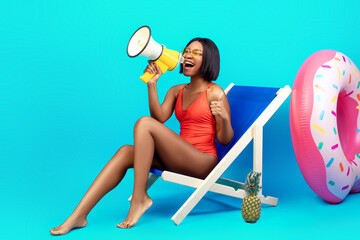 Unbelievable offer. Young black woman in swimwear sitting in lounge chair, having beach vacation,...