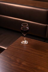 Glass of red wine on table