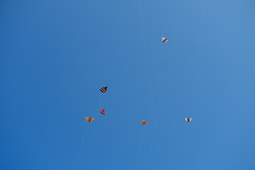 Colorful Kites Flying in Bright Blue Sky