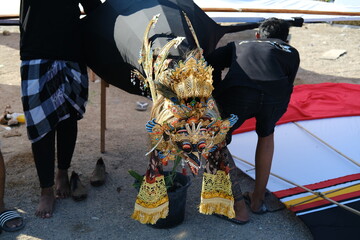 Wooden kite tip shaped like a Balinese god