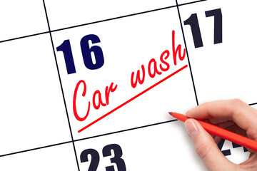 16th day of the month.  Hand writing Car wash reminder and drawing a line on calendar with red pen...
