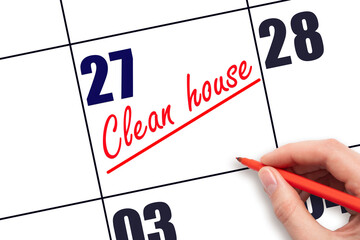 27th day of the month.  Hand writing Clean house reminder and drawing a line on calendar with red...