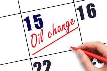 15th day of the month.  Hand writing Oil change reminder and drawing a line on calendar with red...