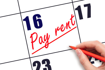 16th day of the month.  Hand writing Pay rent reminder and drawing a line on calendar with red pen...