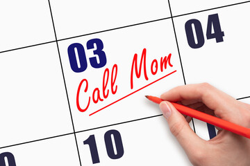 3rd day of the month.  Hand writing Call Mom reminder and drawing a line on calendar with red pen...