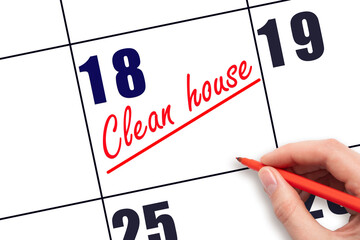 18th day of the month.  Hand writing Clean house reminder and drawing a line on calendar with red...