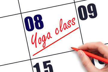 8th day of the month.  Hand writing Yoga class reminder and drawing a line on calendar with red pen...
