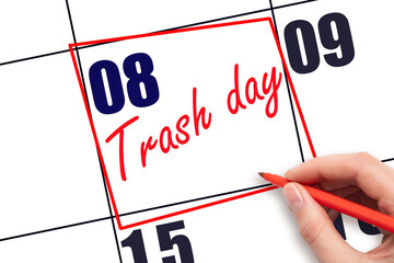 8th day of the month.  Hand writing Trash day reminder and drawing red frame on calendar with red...