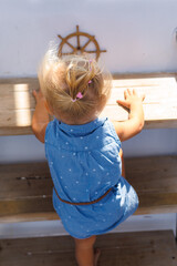 Toddler climbing wooden boat stairs