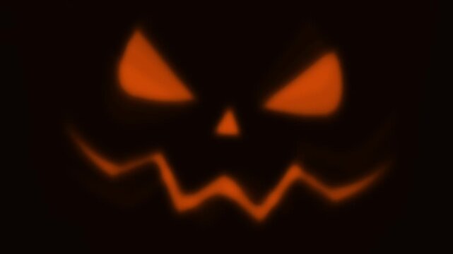 Scary halloween jack o lantern pumpkin face laughing animation loop on dark background