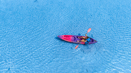 Aerial view of a kayak in the blue sea .woman kayaking he does water sports activities.