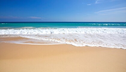 Calm ocean waves gently lapping a pristine sandy shore under a vibrant blue sky