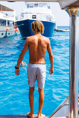 Man standing on boat near Red Sea