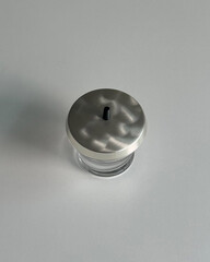 Glass jar with brushed metal lid.