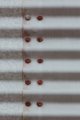 Corrugated Steel Grain Bin Texture with Rusted Metal Bolts Close Up