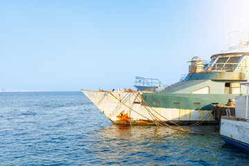Rusty ship docked at sunny harbor